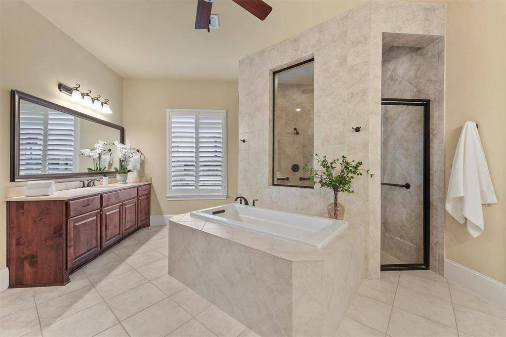 Primary bathroom with dual sinks,separate tub and walk in shower