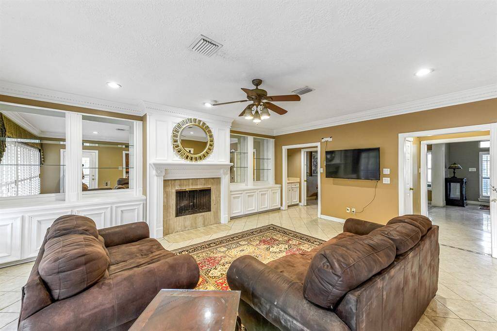 The family room in this home seamlessly flows into the kitchen, creating an open-concept layout that enhances the feeling of spaciousness and connection