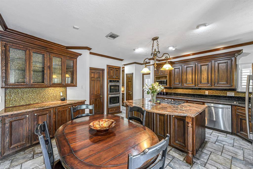 Gas cooktop and double ovens are sure to please the chef in the family