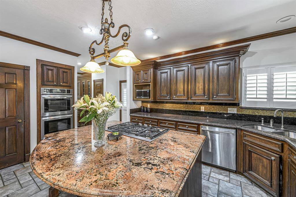 To highlight the stunning granite countertops, the kitchen features over and under cabinet lighting