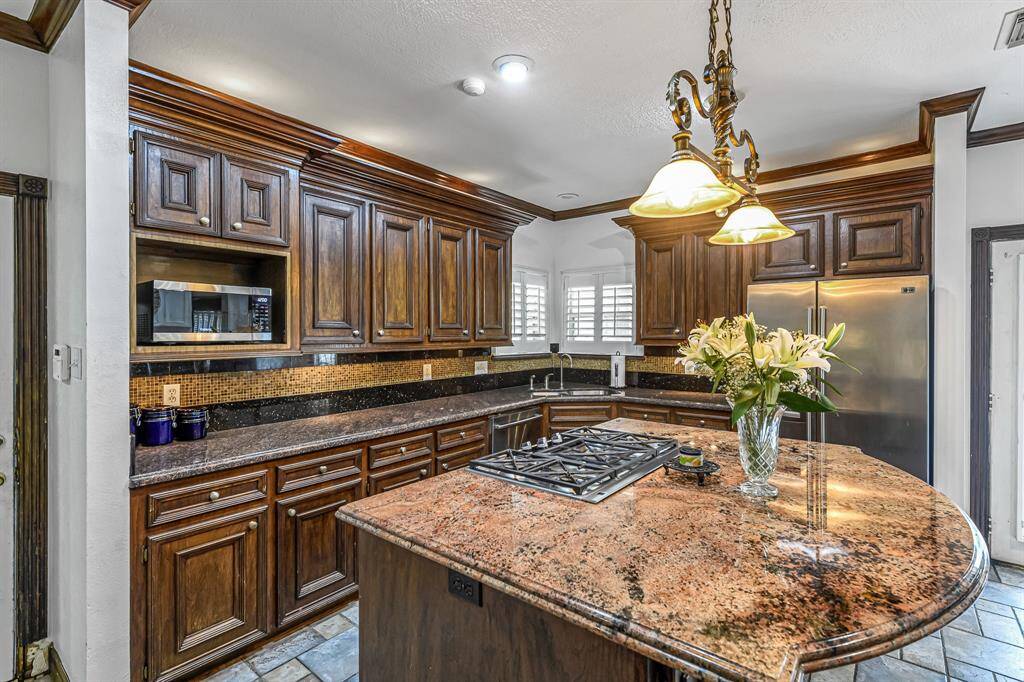 French doors off the breakfast area lead the way to your backyard oasis