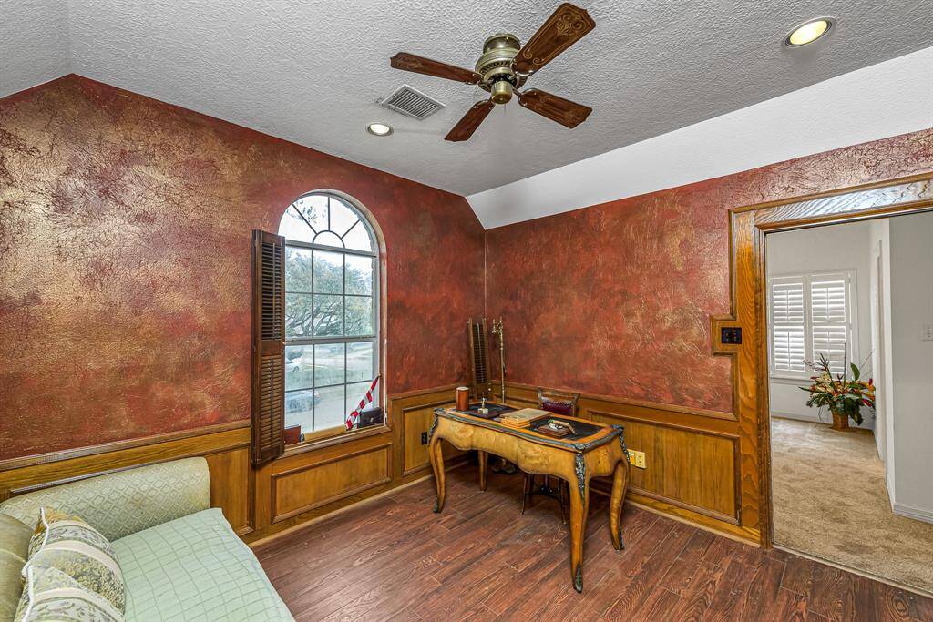 Another spacious secondary bedroom with a reading nook, new carpet, and ceiling fan