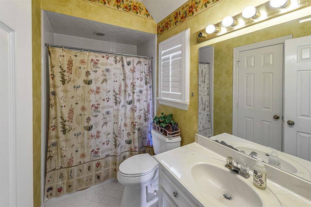Primary bedroom with a wall of windows and French Doors to the balcony overlooking the pool
