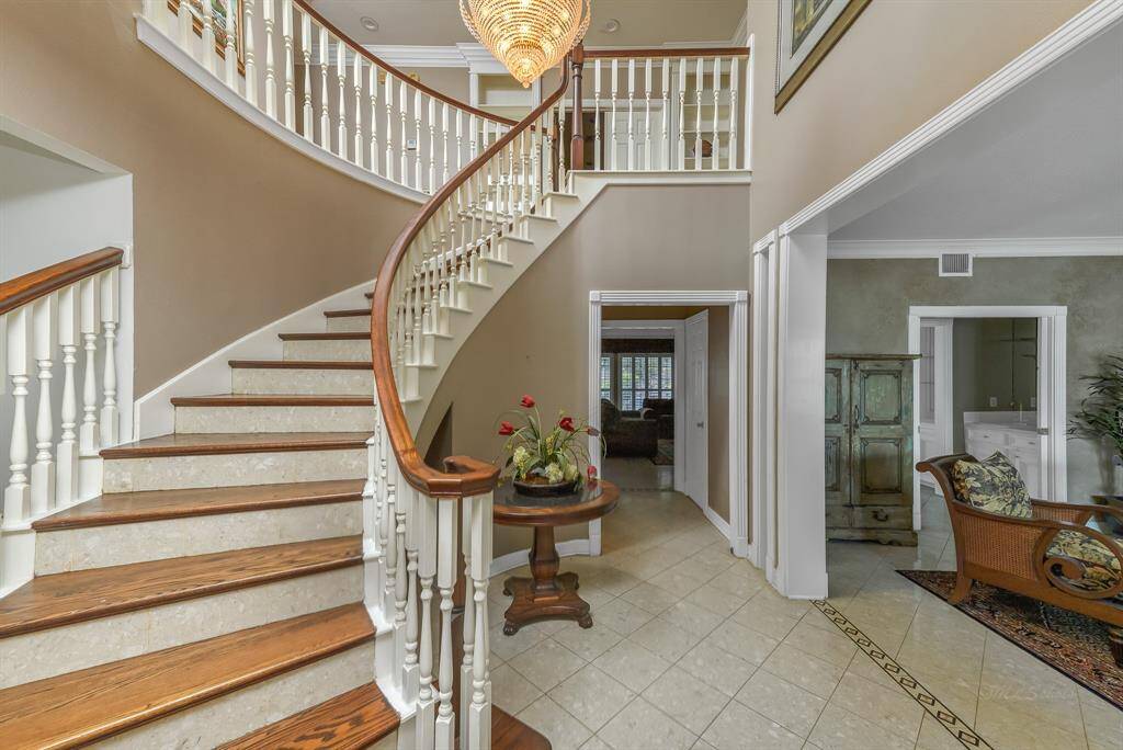 he formal dining room in this home exudes sophistication and warmth, designed to be both an elegant gathering space and a functional part of the home, door to the right leads to the butler's pantry.