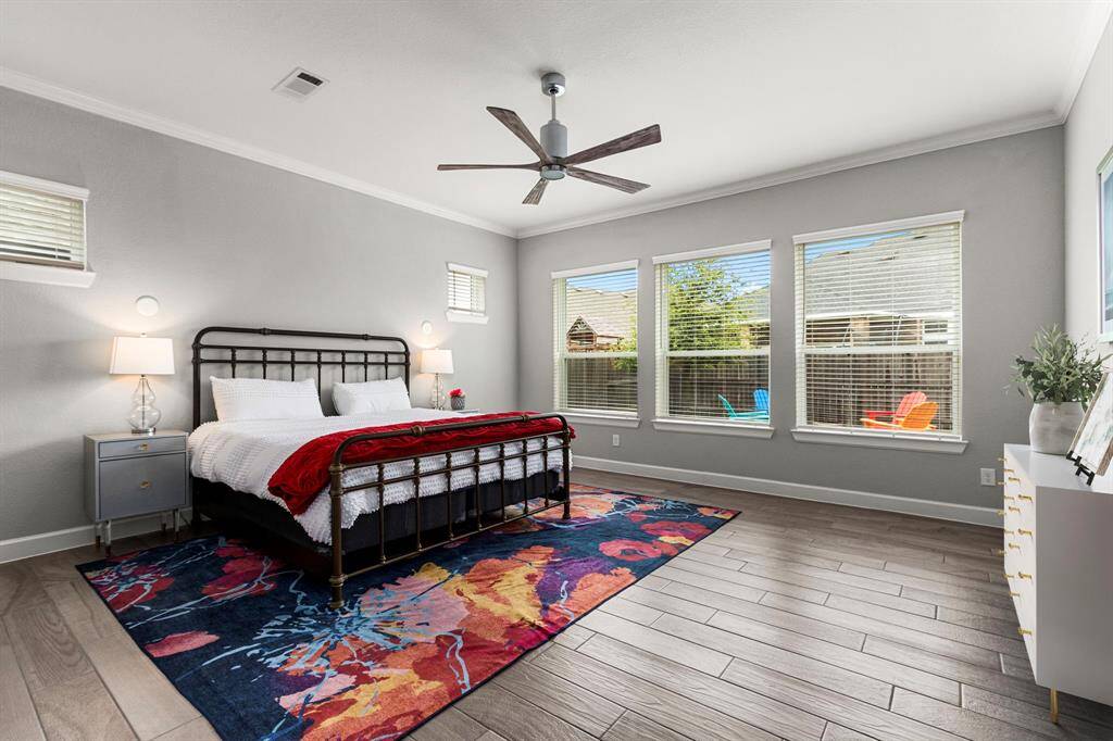 When building the home, the current owners opted for the Extended Owners Suite upgrade to ensure a primary bedroom of impressive scale. Overlooking the backyard, this private retreat is peaceful and bathed in natural light. An upgraded fan, pre-wiring for bedside sconces, and neutral tile flooring set the tone for a space that is calm, relacing, and ready for your personal touch.