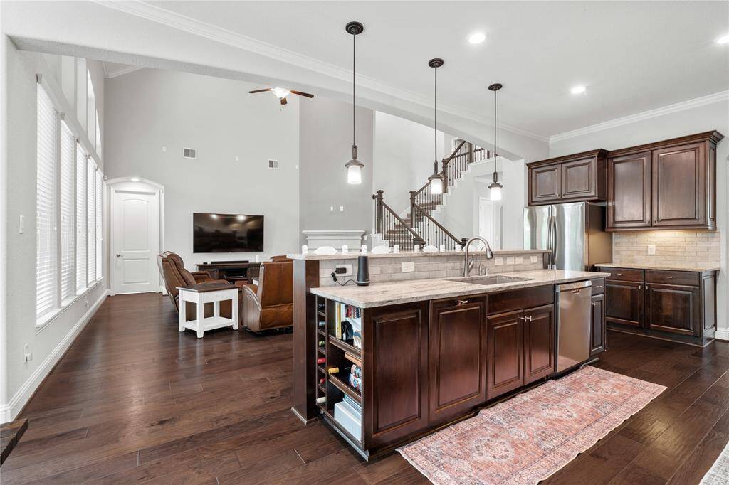 Open concept in the kitchen, living, and breakfast area + high ceilings makes the main living spaces feel huge.