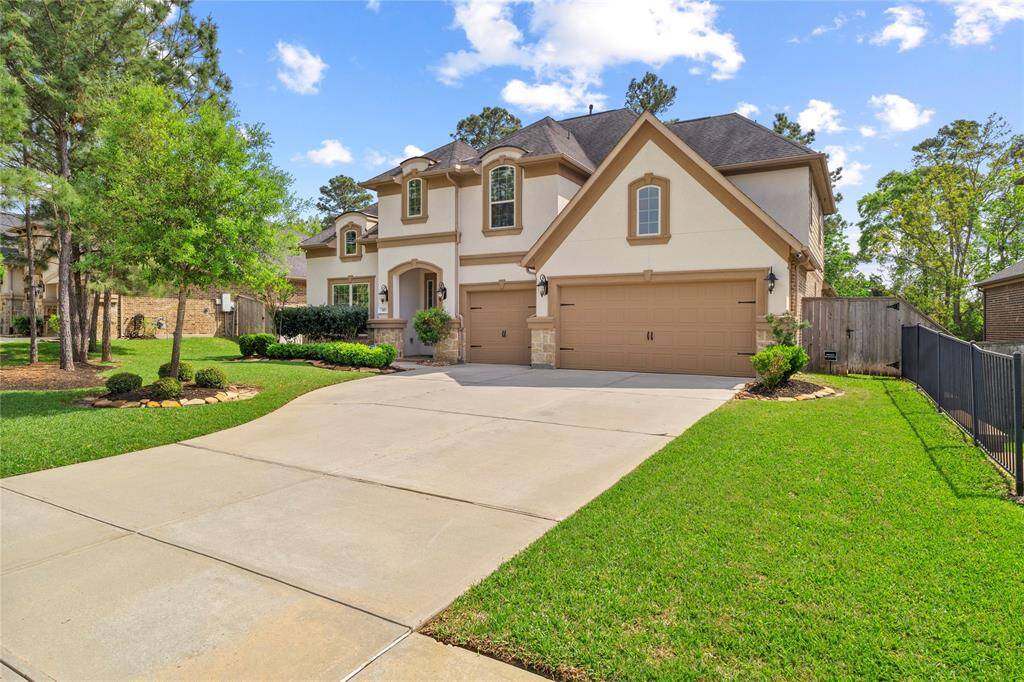 Driveway and three car garage offers ample parking.
