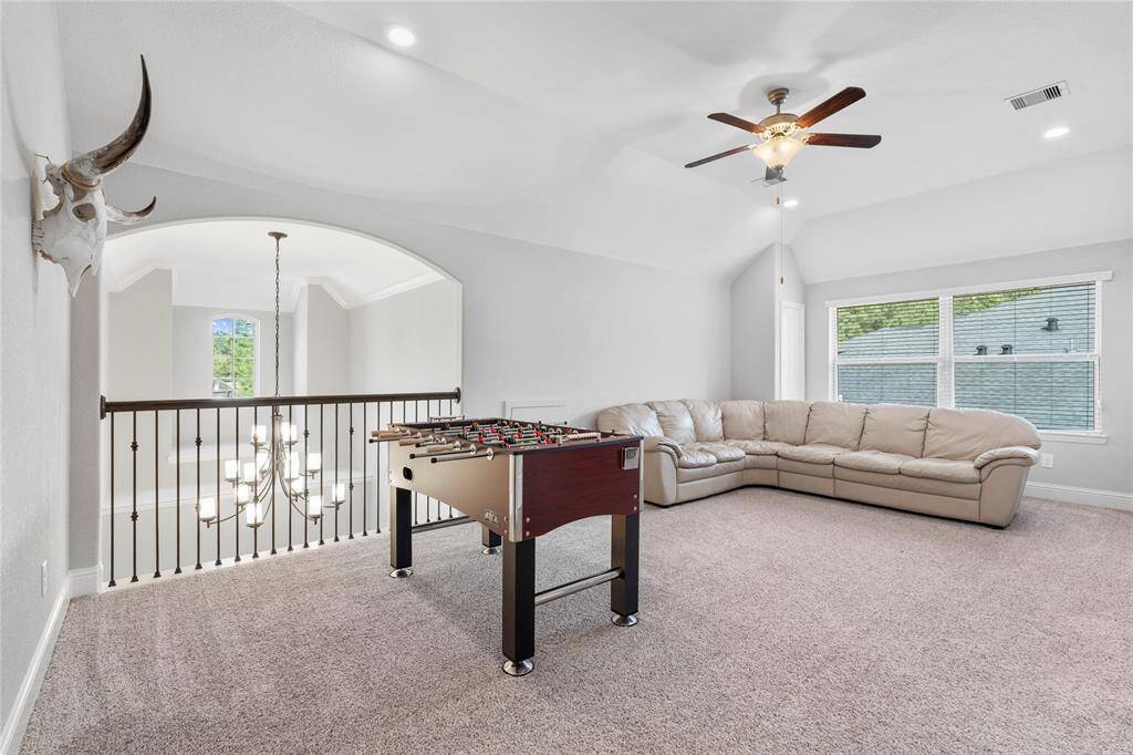 This game room is large and overlooks the entry and living areas, bringing an open feel with views.