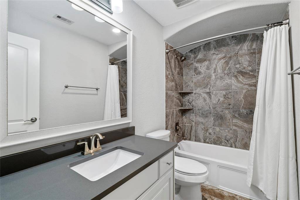 This shower/tub combo gives a clean, bright design with ample lighting completes the space.