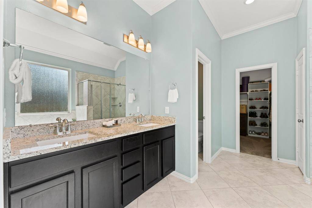 Beautiful ensuite offers dual vanities, a walk-in shower, soaking tub and walk-in closet
