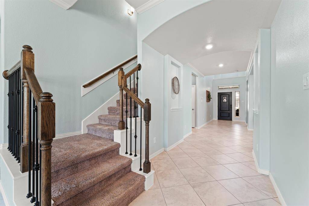 Beautiful stairwell with wood posts and wrought iron spindles