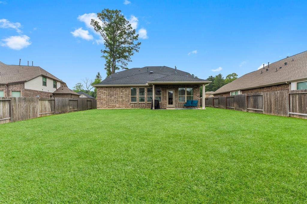 Sprawling back yard is spacious for playing, entertaining, or building a dream pool!