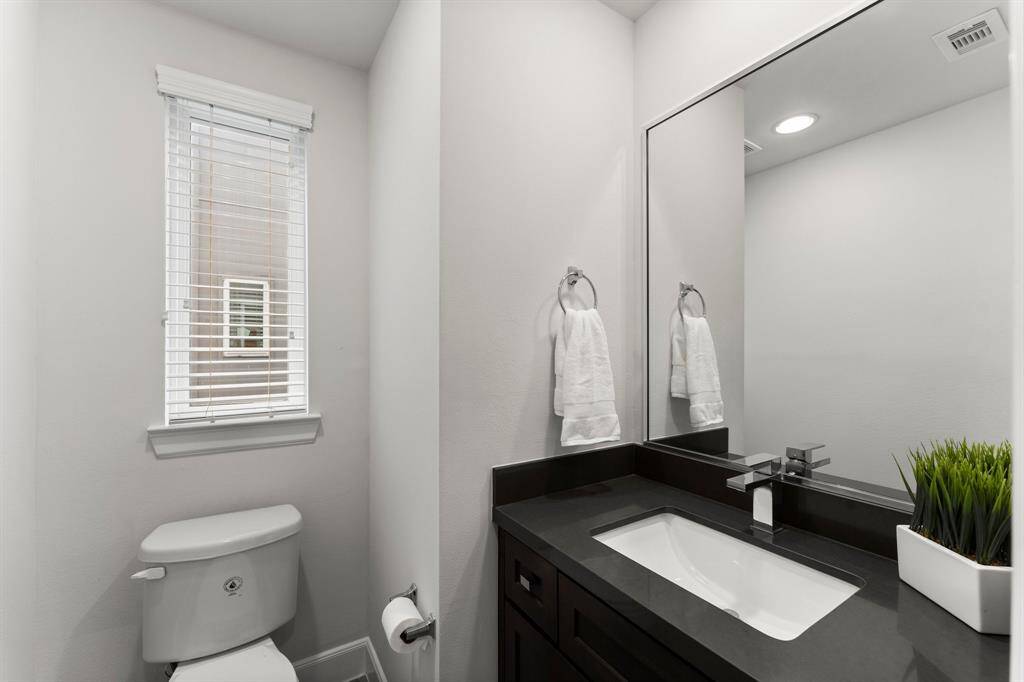 Convenient and stylish half bath, perfect for guests.