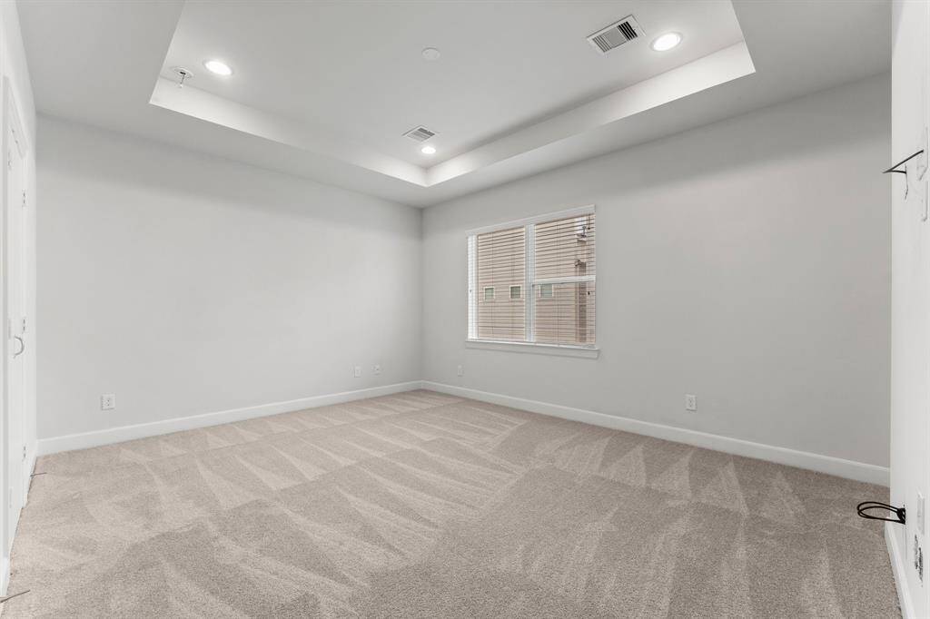 Spacious, primary  retreat with new carpet and freshly painted walls and a tray ceiling.