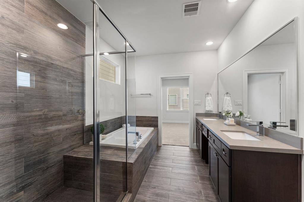 The large mirror and neutral tile flooring enhance the bright, clean look.