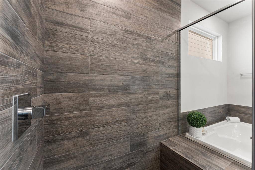 Luxurious shower with elegant wood-look tiles.