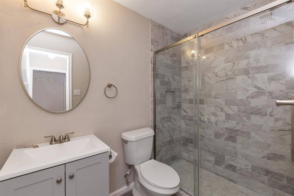 The bathroom features a large shower.
