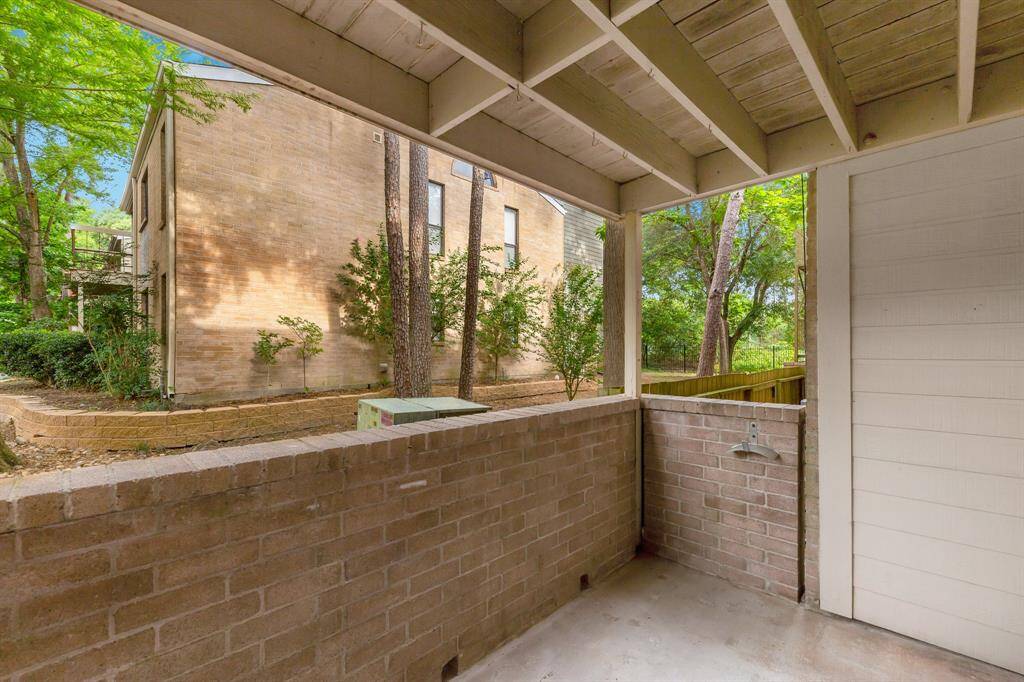 Your private patio is surrounded by a brick wall.