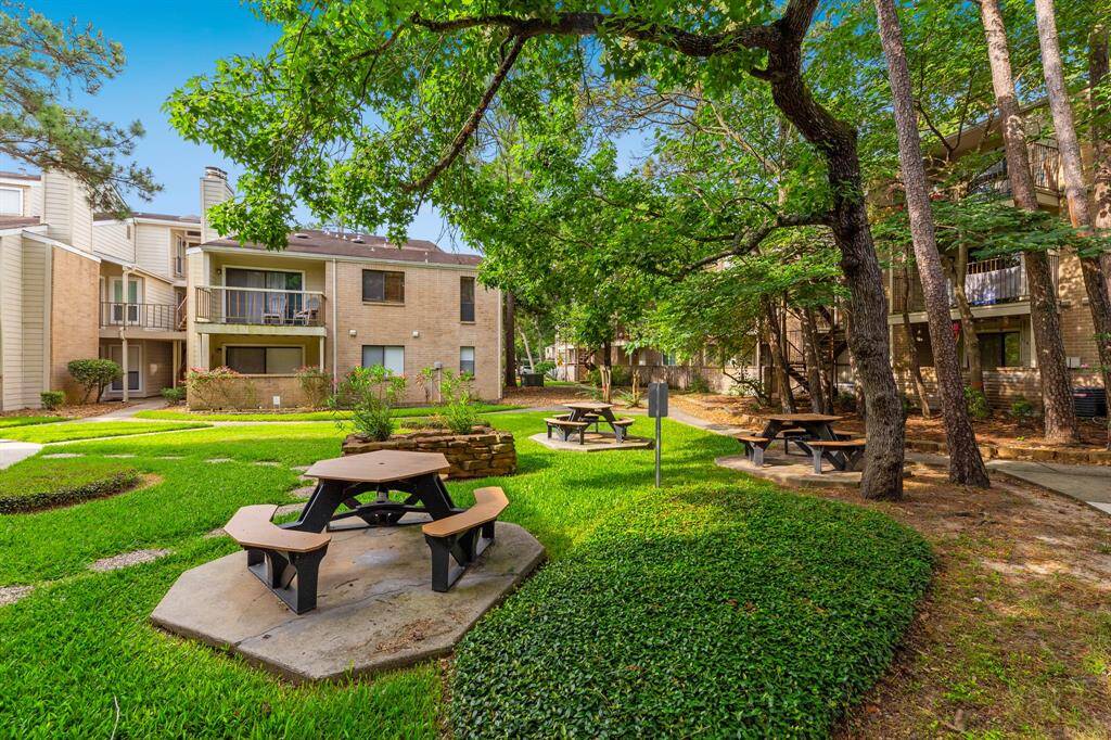 The back patio offers a beautiful view of the common green areas.