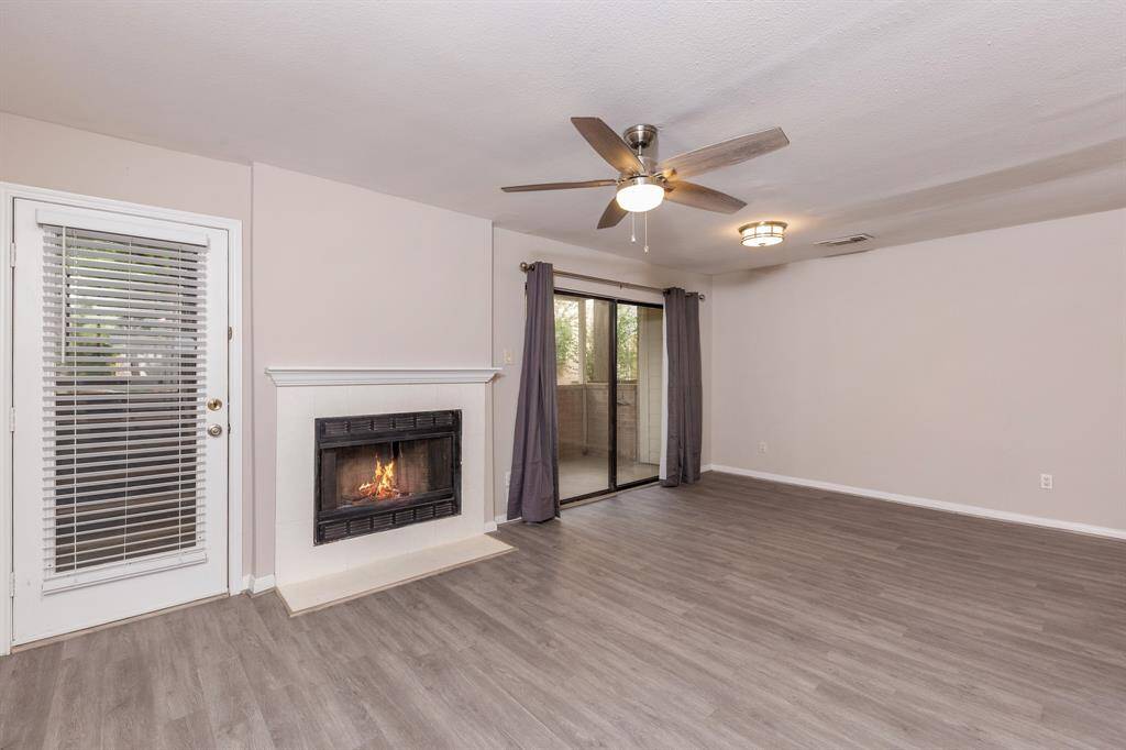 As you enter the home, you are greeted by an inviting fireplace.