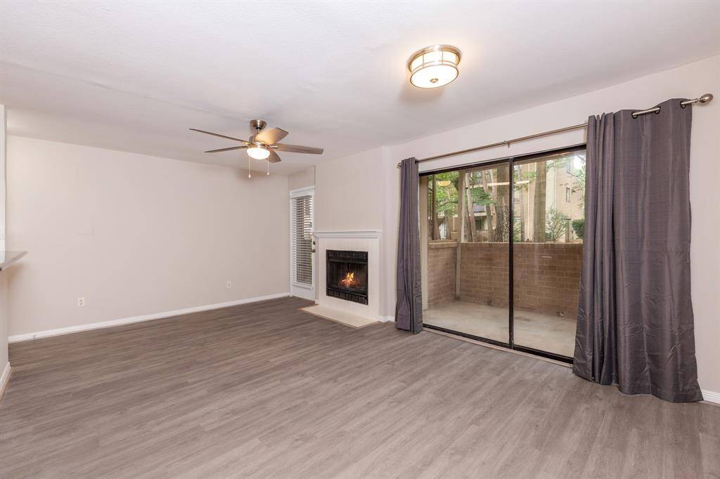 The large windows overlook the back patio, which in turn offers a view of the back greenspace.