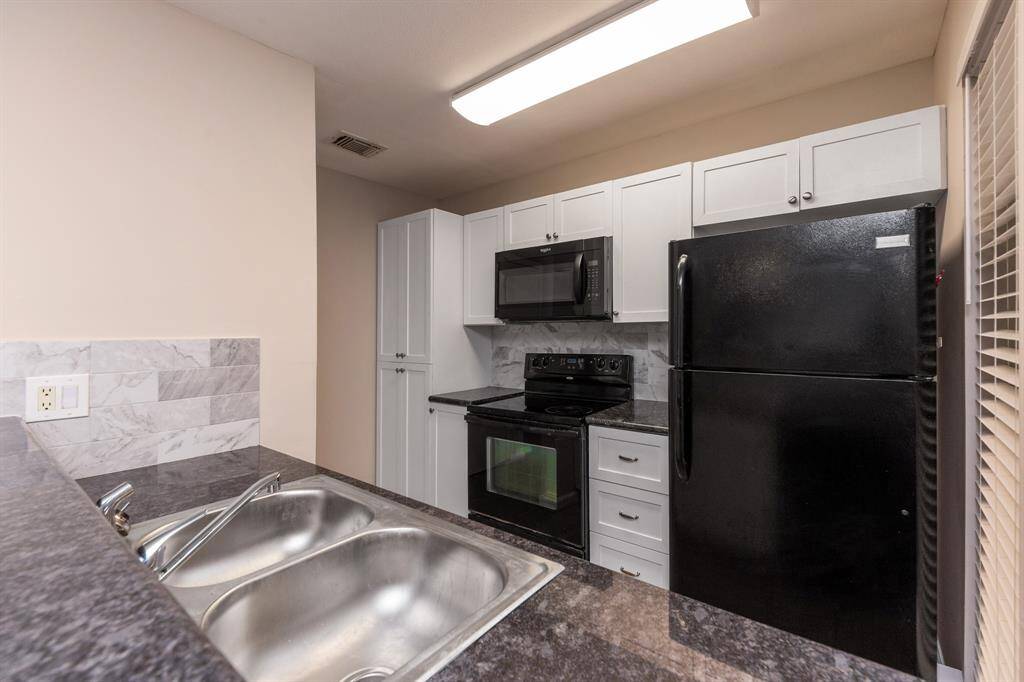 This light and bright kitchen offers plenty of storage space.
