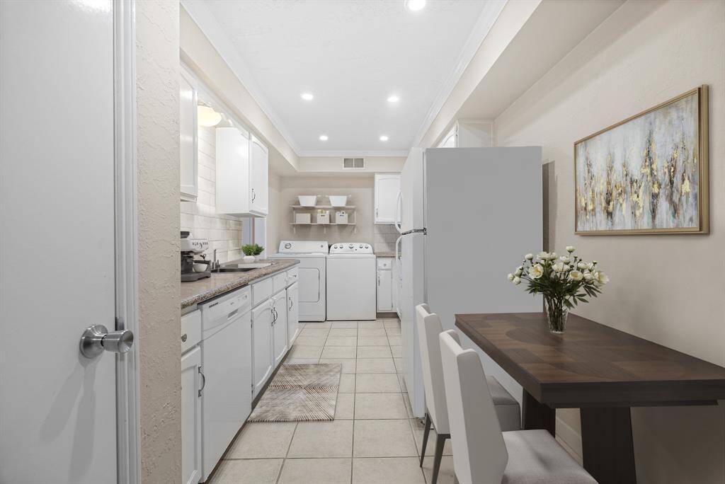 Virtually Staged: Kitchen with tile floors, recessed lighting, and crown molding details.