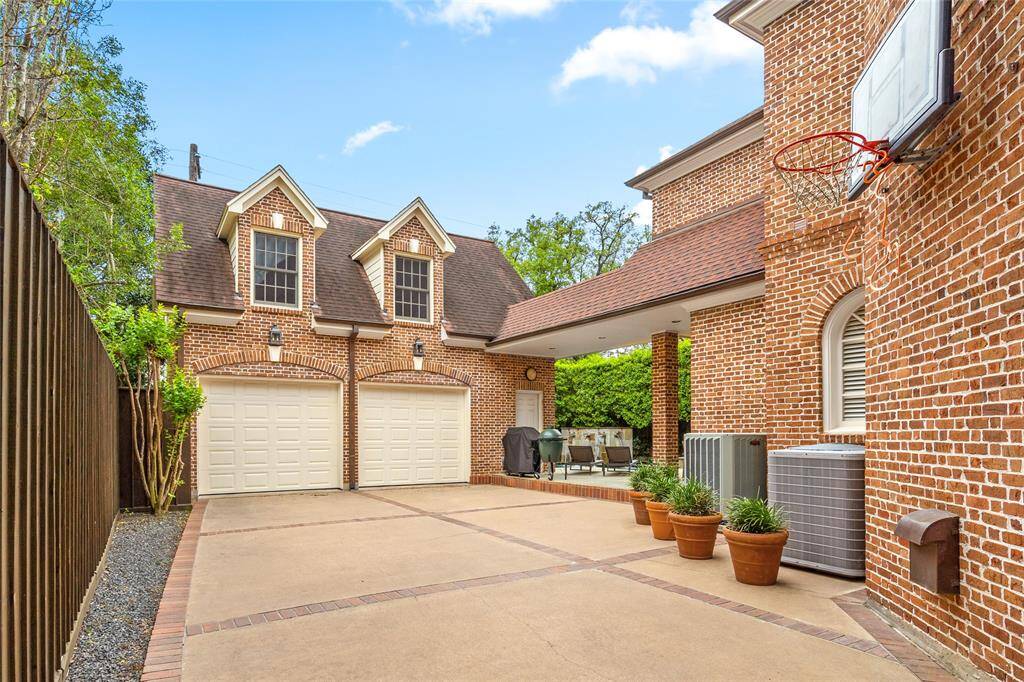 Gated driveway with plenty of room for basketball and access to oversized two-car garage