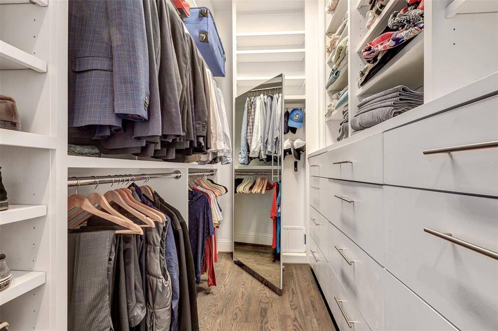 Second primary large walk in closet has plenty of hanging space, drawers, shelves, and accessory cabinet to meet clothing storage needs