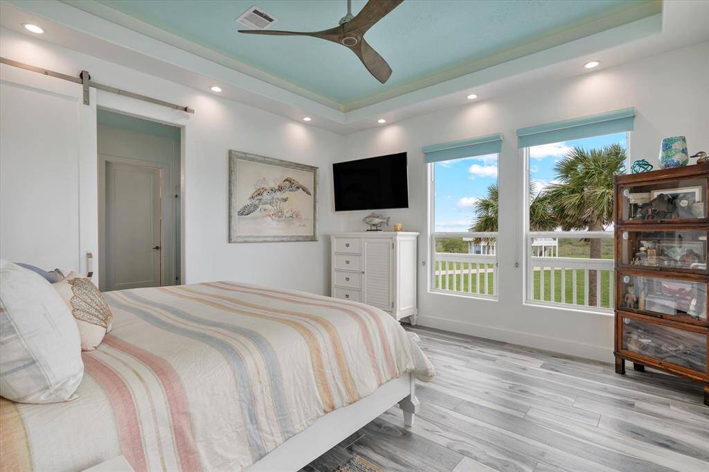 Barn door leading the the primary bathroom