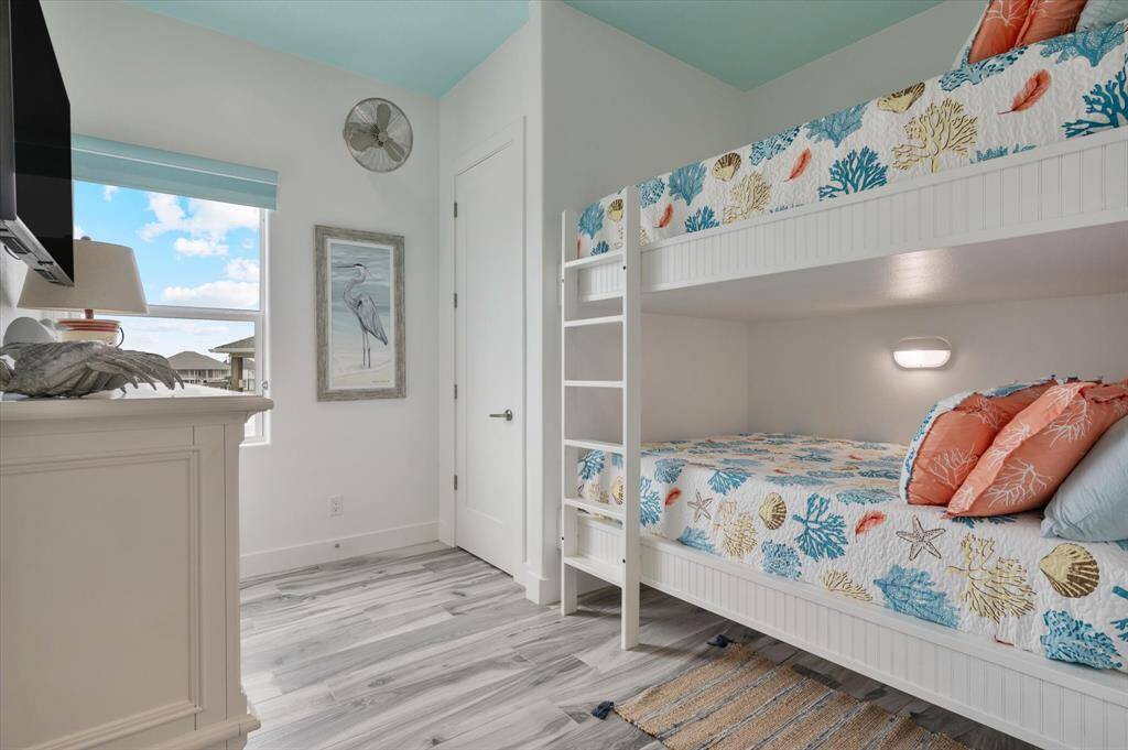 Third secondary queen over queen bunk bedroom with accent lights for both beds
