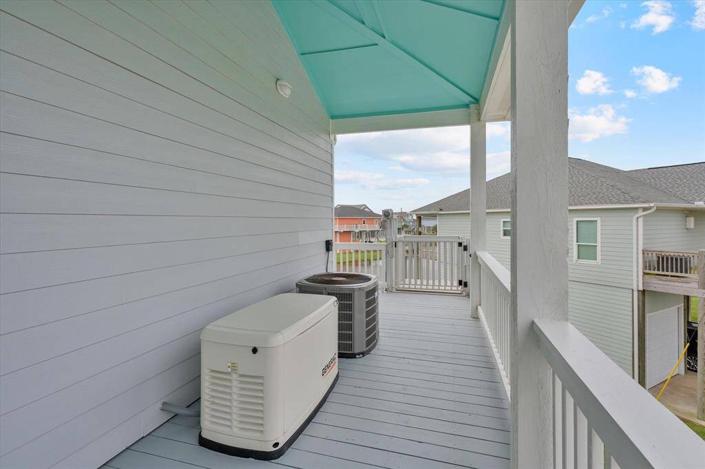 Whole house generator and AC on the back side of the home, protected from the direct salt breeze.  Notice the cargo lift in the distance