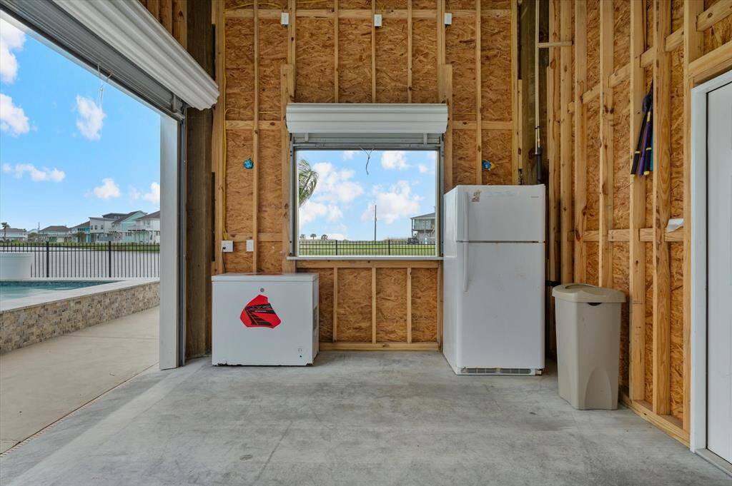 Inside the garage near the pool. Freezer and refrigerator stays