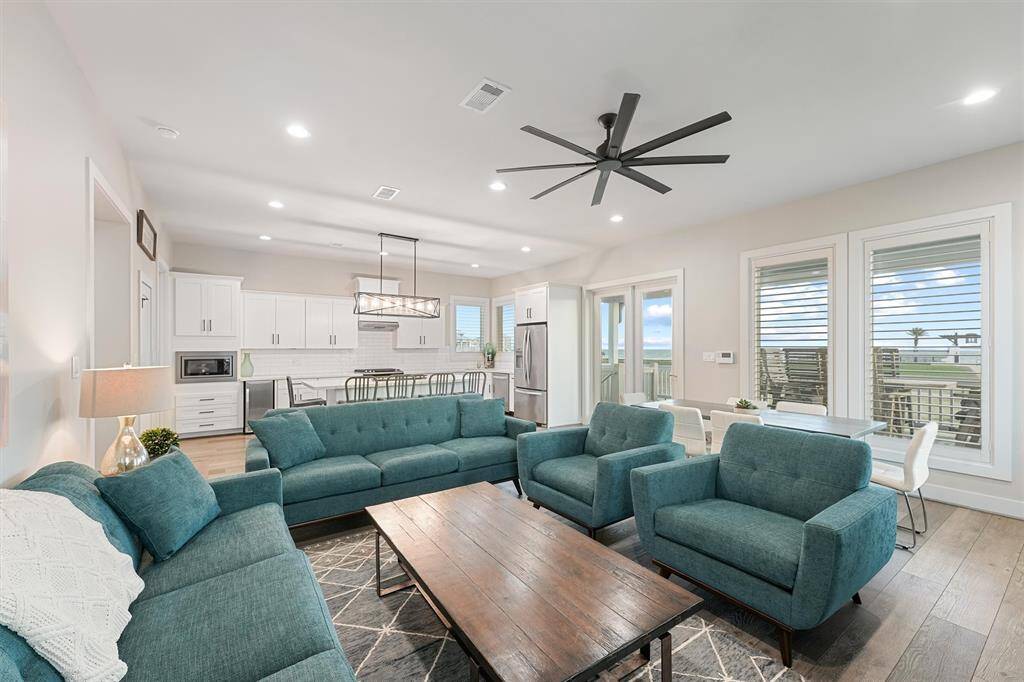 An entertainer's dream, this open-concept living area flows seamlessly into the kitchen and dining spaces, all while offering stunning natural light and views. Perfect for gathering and making memories.