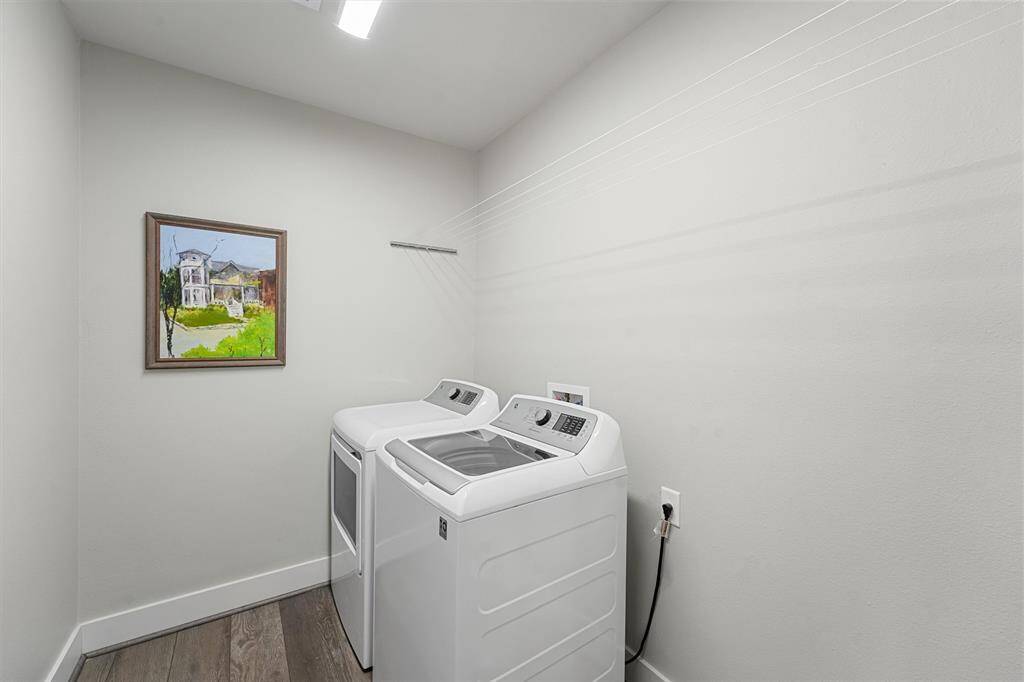 Charming and functional, this bathroom features modern finishes, a sleek walk-in shower, and natural light that enhances its bright and airy feel.