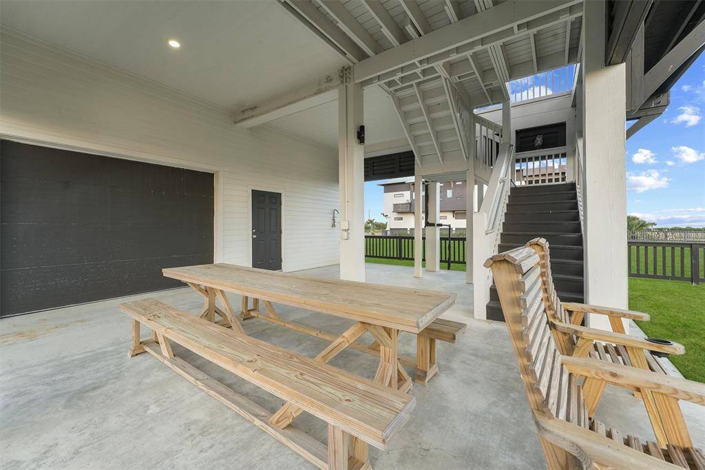 Enjoy the ultimate outdoor lifestyle with this spacious covered patio, perfect for al fresco dining and relaxing in the shade. A great spot to unwind after a day at the beach.
