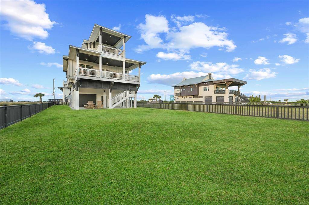An expansive, fenced backyard with unobstructed views creates a private oasis just steps away from the beach and community amenities. A perfect space for outdoor fun and relaxation.