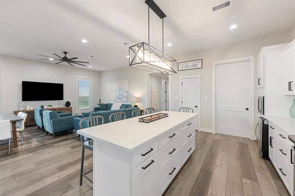 This stunning kitchen combines style and functionality, featuring sleek quartz countertops, a spacious island, and top-of-the-line appliances. Perfect for entertaining or enjoying quiet mornings by the beach.