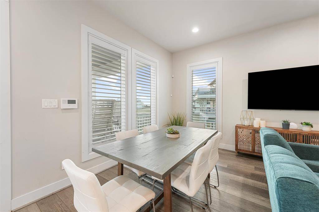 Open and inviting, this dining and living area is designed for effortless entertaining and relaxation. With modern furnishings, plenty of seating, and natural light throughout, it’s the perfect gathering place for family and friends.