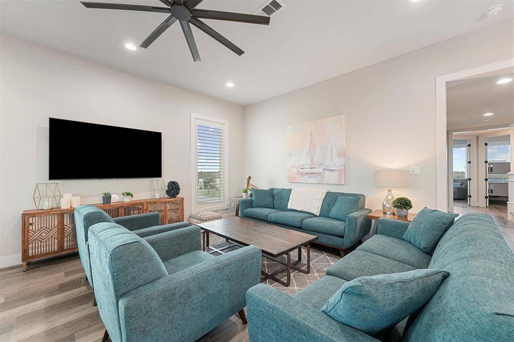 Bright and welcoming, this dining space is perfect for gathering around the table with family and friends. Enjoy natural light and views through the large windows, adding a coastal charm to every meal.