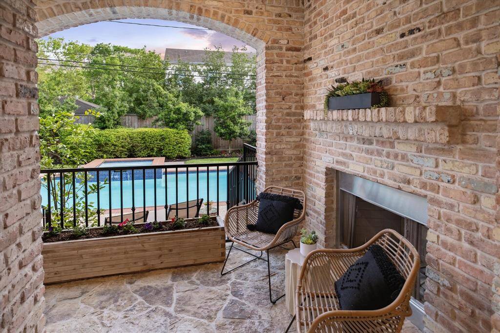 OUTDOOR KITCHEN.   A built-in stainless steel grill and outdoor kitchen, installed in 2021. Note the pretty flagstone paved stone floor.