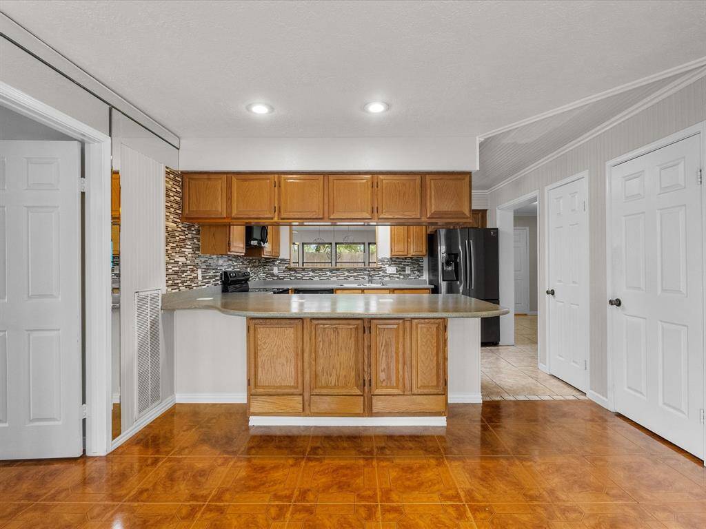 Kitchen view with wraparound counter space, tons of cabinet storage, and a perfect pass-through to the dining area.