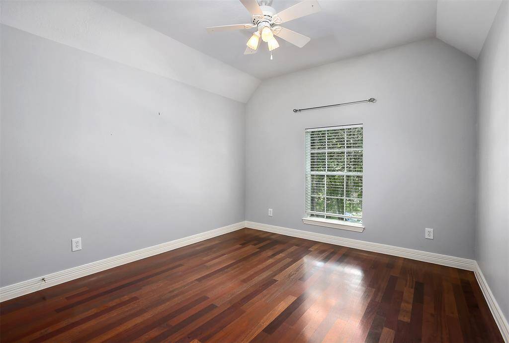 Bedroom 1 offers a bright and airy retreat at the front of the house, featuring stunning vaulted ceilings