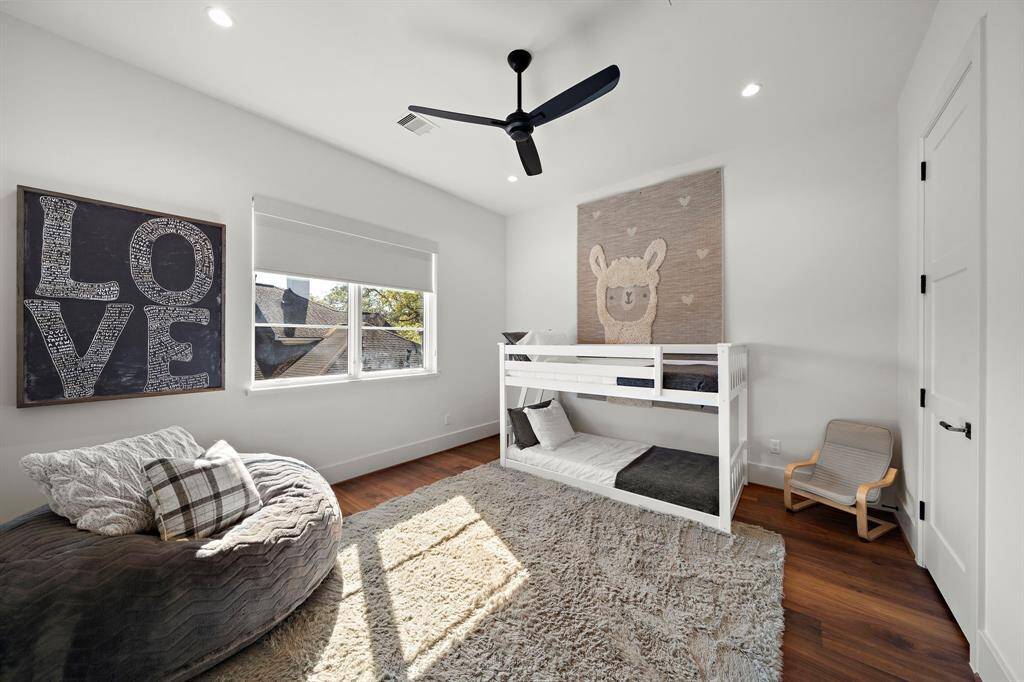 Bathed in natural light, this upstairs bedroom (14'x13') with 10' ceilings delivers an inviting layout and warm aesthetic, seamlessly blending comfort with the elevated craftsmanship seen throughout the home.