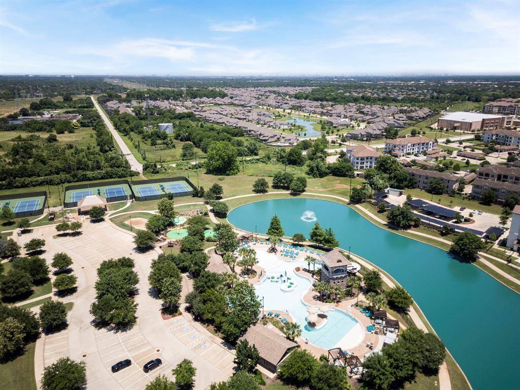 Enjoy resort-style living at Riverstone with this view of the sparkling pool, scenic lake, and top-notch tennis courts. Whether you're relaxing by the water, playing a match, or taking a dip, these amenities provide endless opportunities for recreation and relaxation.