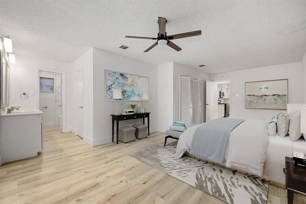 Come and unwind after a long day in this magnificent primary suite! This spacious room features luxury vinyl flooring, neutral paint, high ceilings, beautiful custom ceiling fan and large windows with privacy blinds.