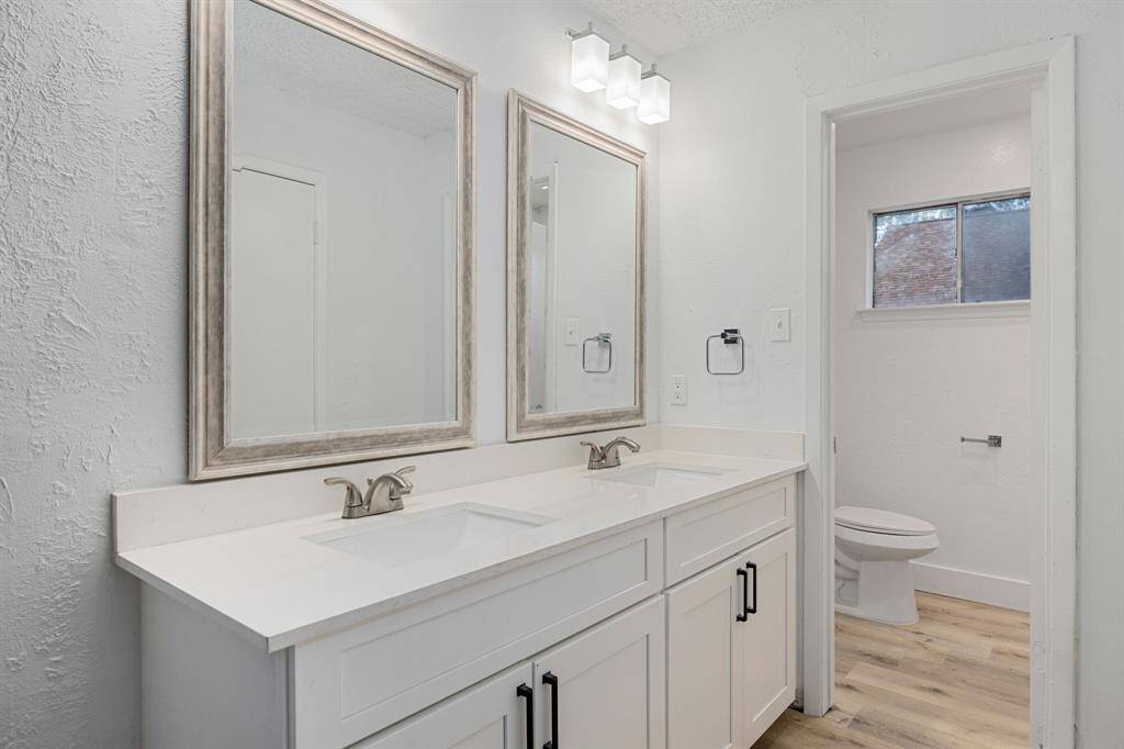This primary bathroom is definitely move-in ready! Featuring double sinks, bright cabinets with light countertops, spacious walk-in closet with shelving, high ceilings, neutral paint, sleek and modern finishes.