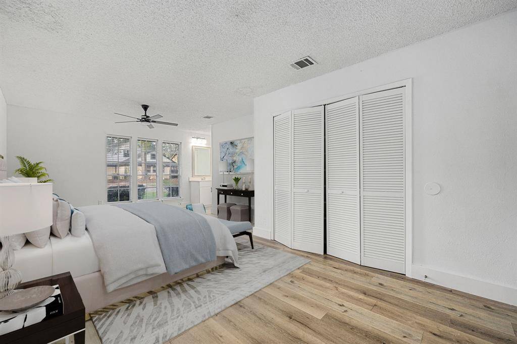 What a wonderful place to come home to, this stunning primary suite greets you with gorgeous luxury vinyl plank floors, custom paint, high ceiling, lovely windows with blinds allowing in natural light brightening up this spacious primary bedroom, with extra space for a seating area.