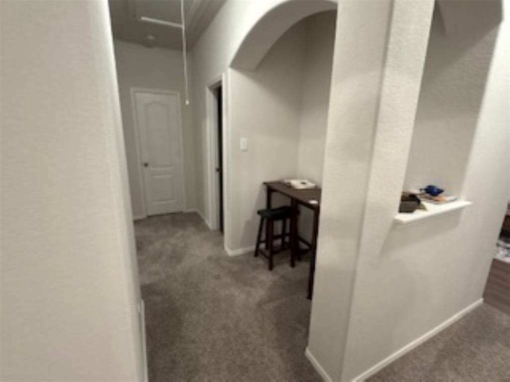 There is an arched opening on one side leading to a nook.