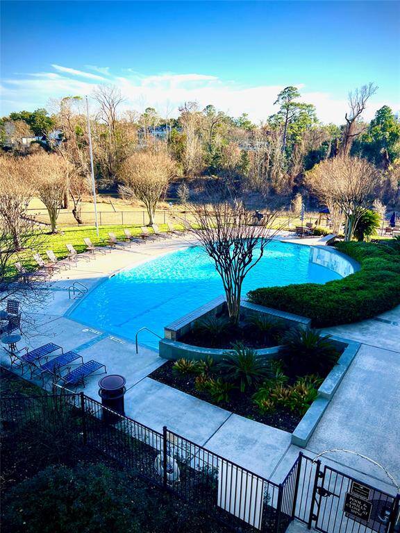 Large pool with lots of tranquil green space.